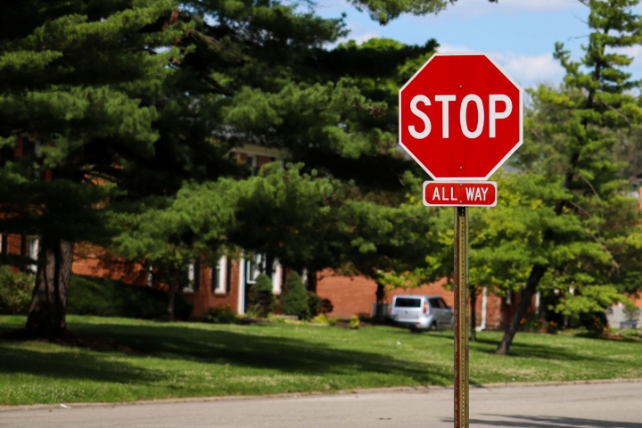 A street intersection featuring a red stop sign with an "ALL WAY" tab attached below it.