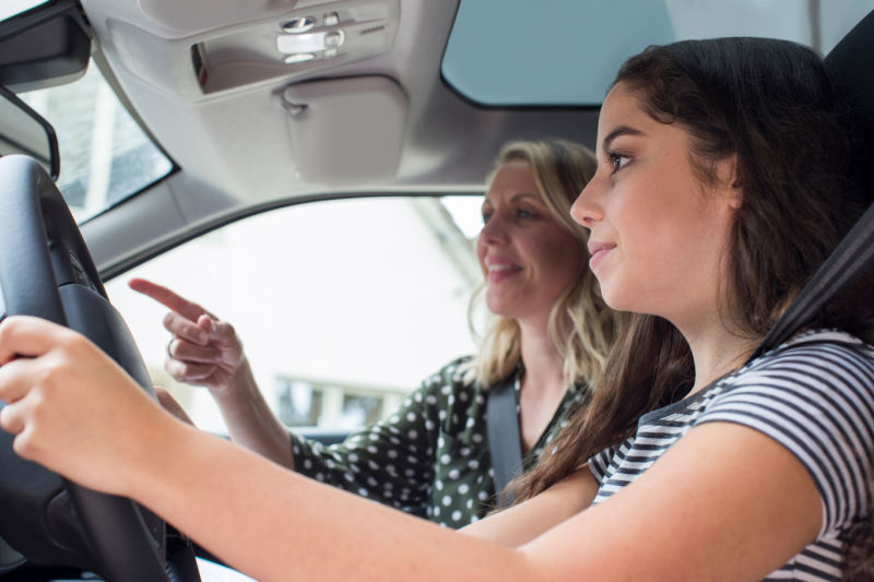 Teenager Having Driving Lesson With Female Instructor