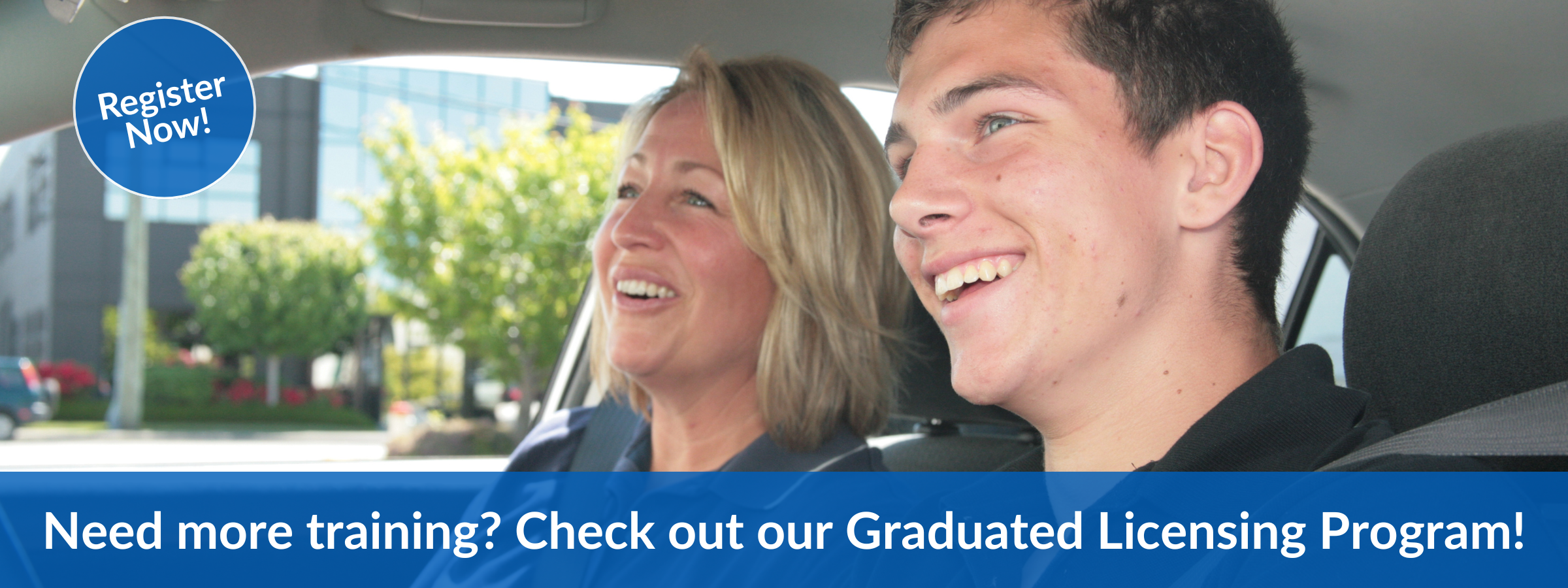Register for our Graduated Licensing Program: A happy young driver and driving instructor inside a car during a professional training session.