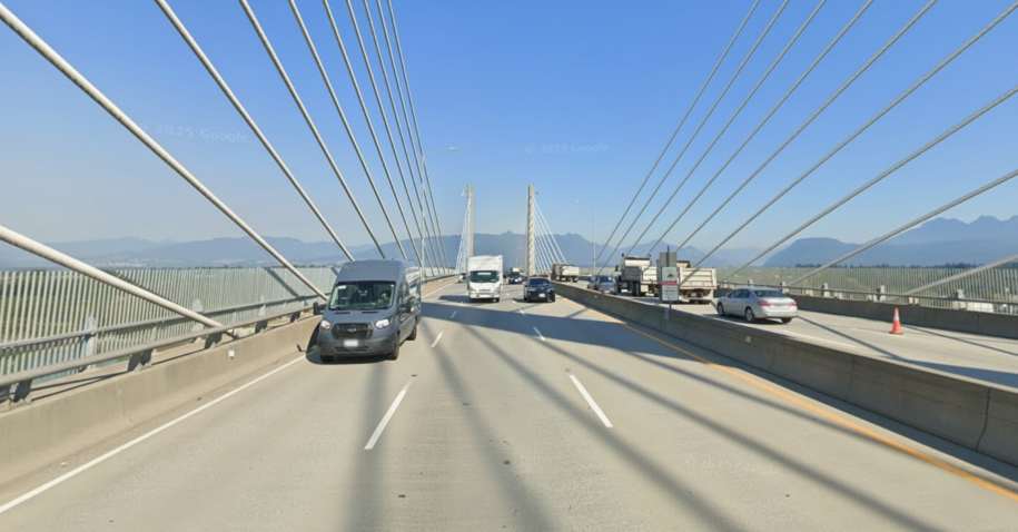 6 lane bridge with cars, trucks vans driving across.