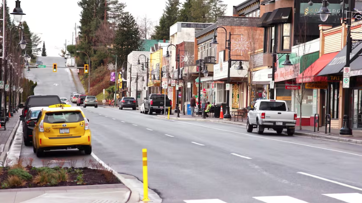 Downtown mission road with vehicles parked along the side of the road.