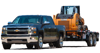 A black Chevrolet pickup truck towing a flatbed trailer carrying a yellow Case skid steer loader, demonstrating heavy-duty equipment hauling and trailer towing.